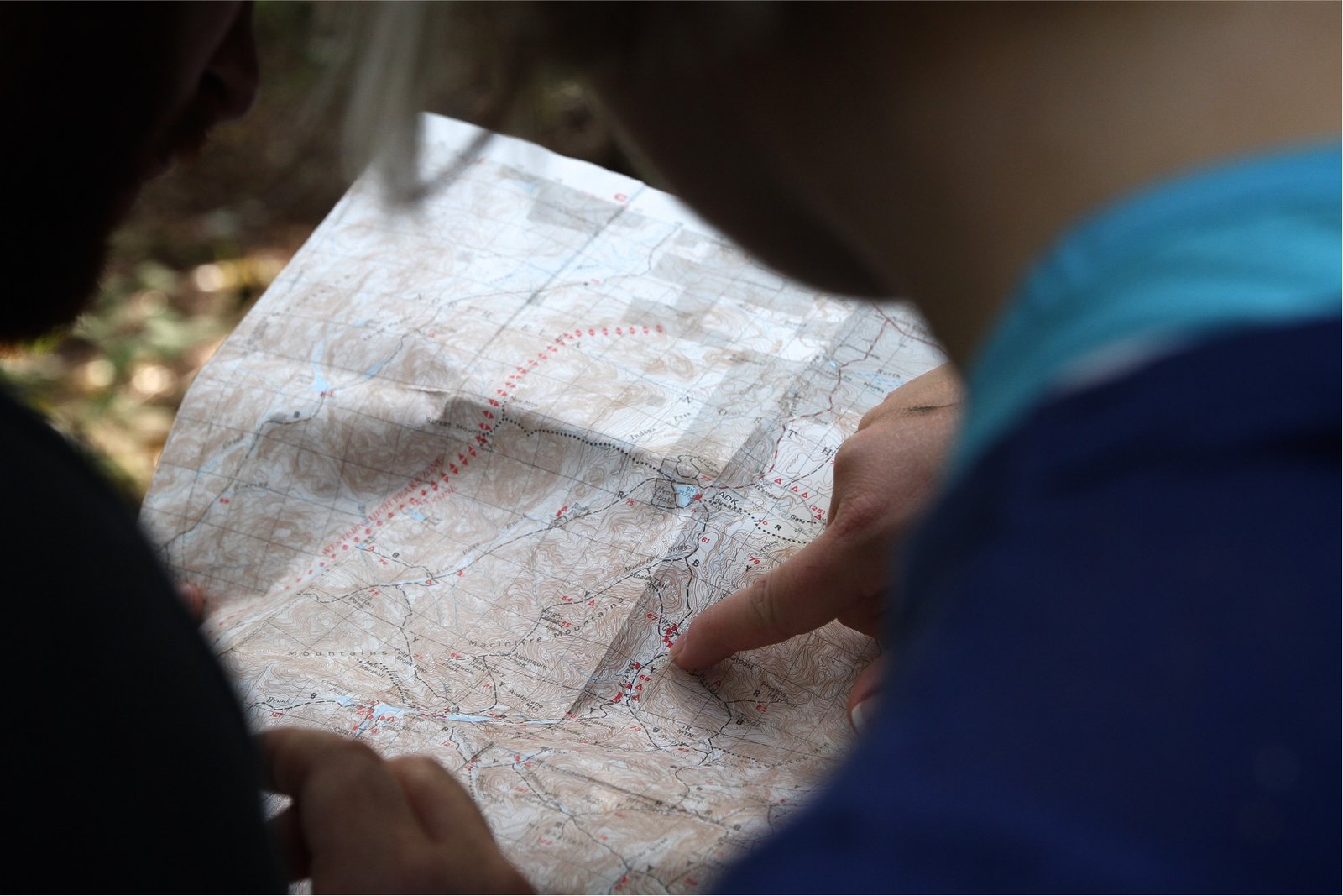 A person points to a location on a map